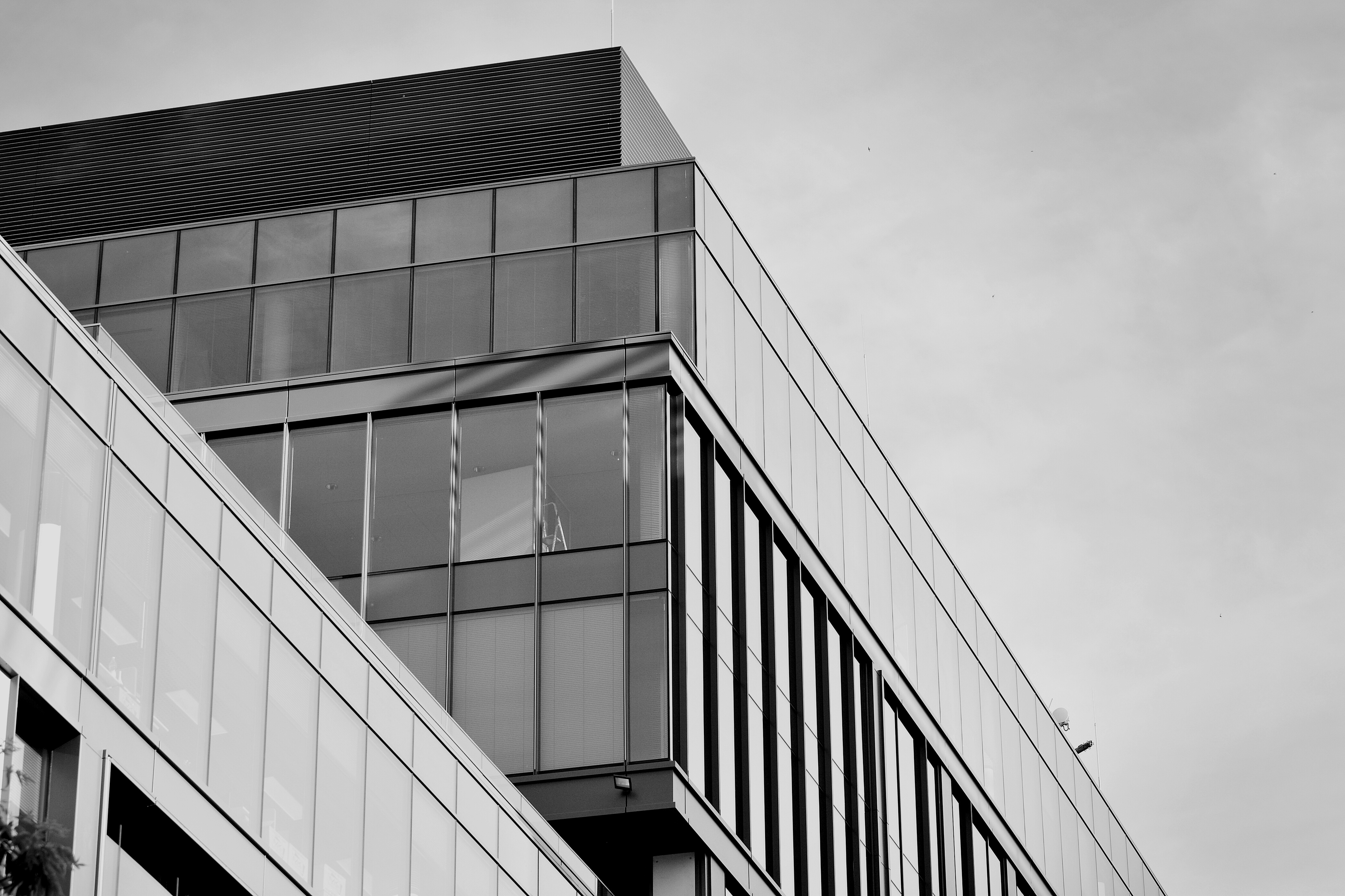 Modern office building wall made of steel and glass. Black and white.